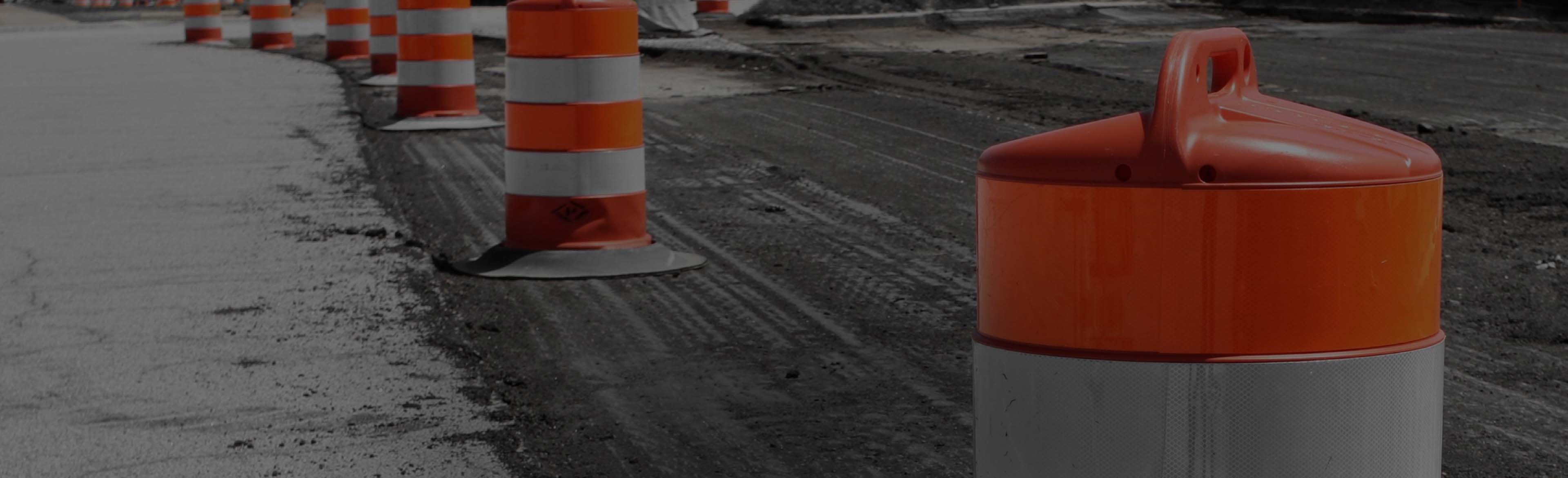 Traffic control barrels in a roadway construction zone.